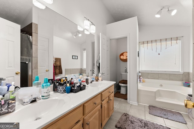 625 Hickory Nobb, Sugar Hill, GA 30518 - bathroom with a bath, tile patterned flooring, double vanity, lofted ceiling, and a shower