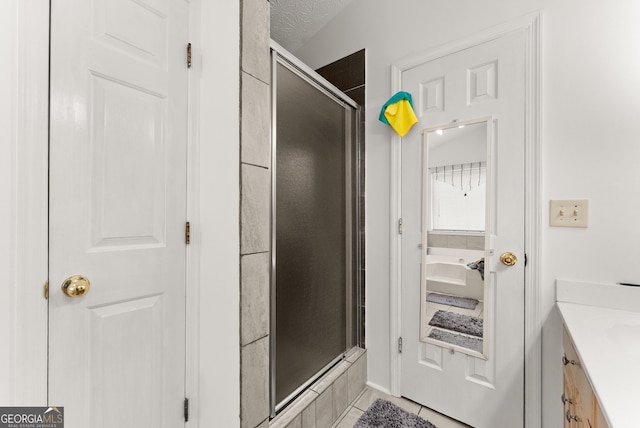 625 Hickory Nobb, Sugar Hill, GA 30518 - bathroom with a shower stall, vanity, a bath, and tile patterned floors