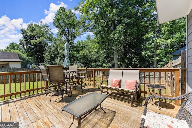 625 Hickory Nobb, Sugar Hill, GA 30518 - wooden terrace featuring a fenced backyard, outdoor dining area, and view of scattered trees