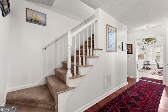 625 Hickory Nobb, Sugar Hill, GA 30518 - stairway with wood finished floors and a textured ceiling