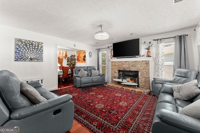 625 Hickory Nobb, Sugar Hill, GA 30518 - living room with wood finished floors, a textured ceiling, and a fireplace
