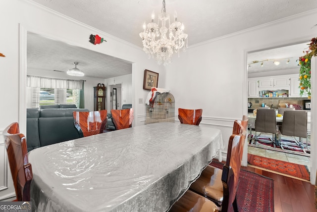 625 Hickory Nobb, Sugar Hill, GA 30518 - dining space featuring a textured ceiling, wood finished floors, ornamental molding, and a chandelier