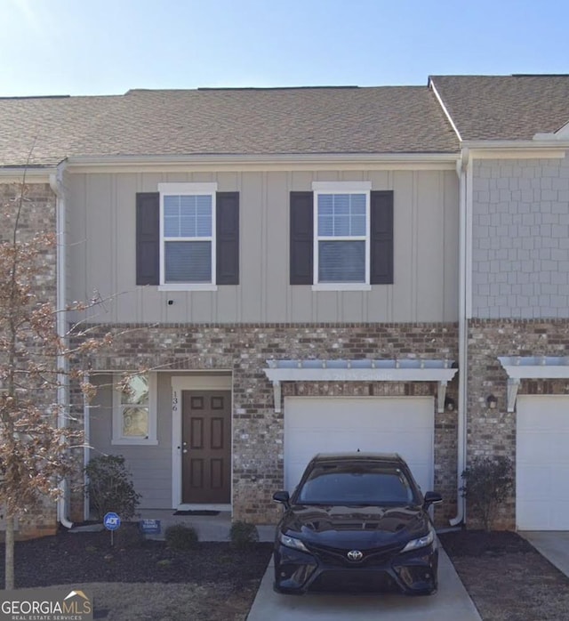 136 Swindon Dr, Mcdonough, GA 30253 - multi unit property with board and batten siding, an attached garage, and brick siding