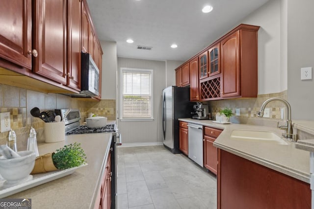 4020 New Salem Ct, Cumming, GA 30040 - kitchen with stainless steel appliances, dark brown cabinets, tasteful backsplash, light countertops, and recessed lighting