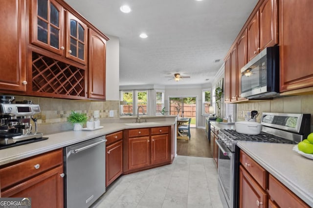4020 New Salem Ct, Cumming, GA 30040 - kitchen with stainless steel appliances, light countertops, decorative backsplash, a peninsula, and recessed lighting