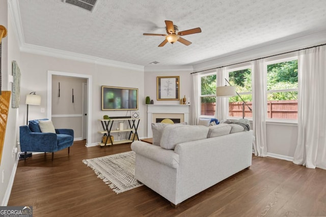 4020 New Salem Ct, Cumming, GA 30040 - living area featuring ceiling fan, a fireplace, dark wood-type flooring, and crown molding