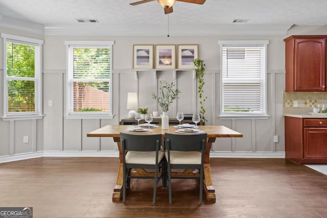 4020 New Salem Ct, Cumming, GA 30040 - dining area with a decorative wall, a ceiling fan, wood finished floors, a textured ceiling, and crown molding