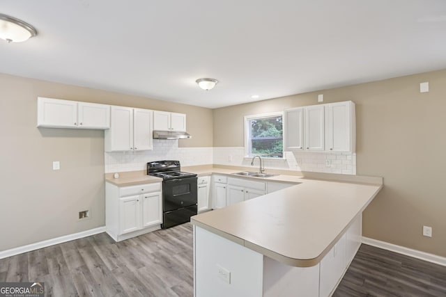 1159 Smith St SW, Atlanta, GA 30310 - kitchen featuring black electric range oven, under cabinet range hood, a peninsula, white cabinetry, and light wood-style flooring
