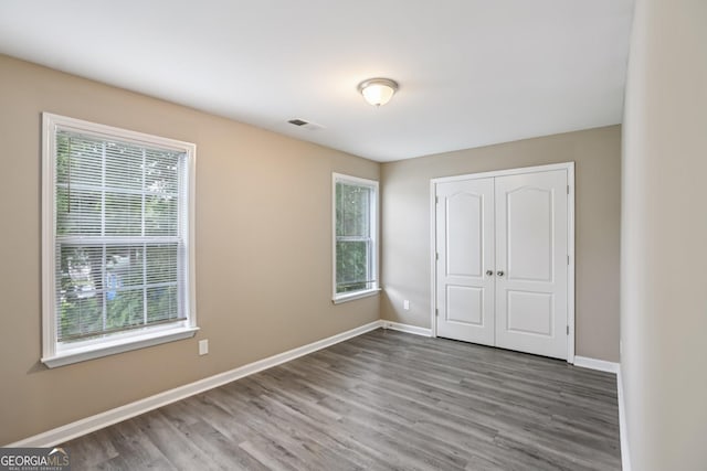 1159 Smith St SW, Atlanta, GA 30310 - unfurnished bedroom with wood finished floors and a closet