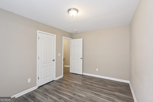 1159 Smith St SW, Atlanta, GA 30310 - unfurnished bedroom with baseboards and wood finished floors