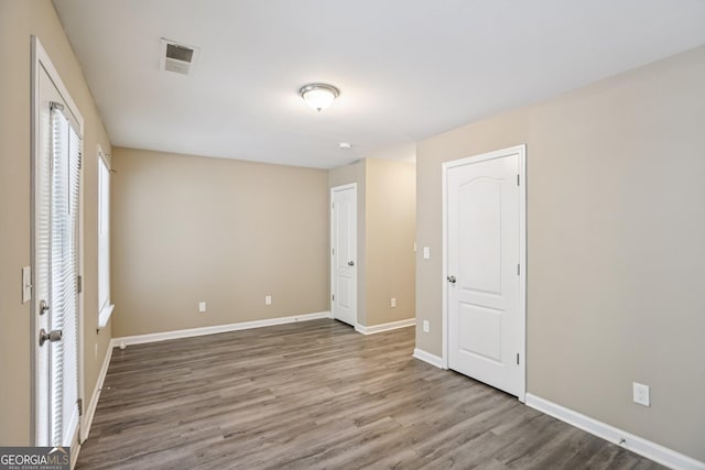 1159 Smith St SW, Atlanta, GA 30310 - unfurnished bedroom with wood finished floors and baseboards