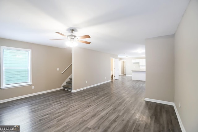 1159 Smith St SW, Atlanta, GA 30310 - unfurnished living room with dark wood-style flooring, stairs, and a ceiling fan