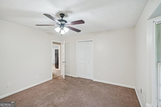 5618 Shadow Rock Dr, Lithonia, GA 30058 - unfurnished bedroom with carpet floors, a closet, and a ceiling fan