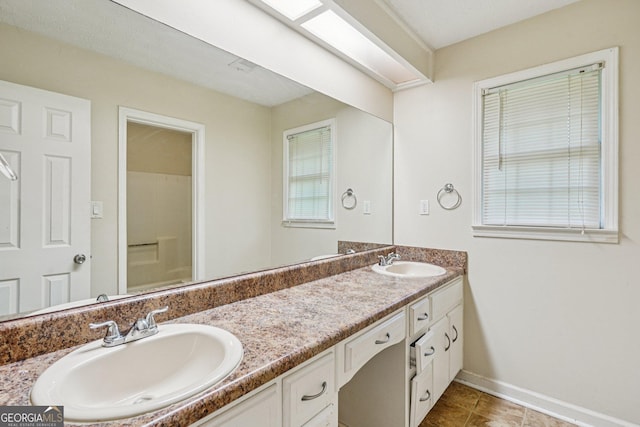 5618 Shadow Rock Dr, Lithonia, GA 30058 - bathroom with double vanity and baseboards