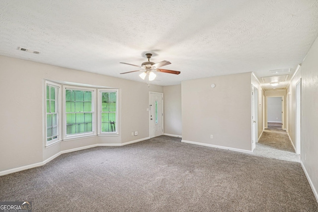 5618 Shadow Rock Dr, Lithonia, GA 30058 - empty room with carpet floors, ceiling fan, and a textured ceiling