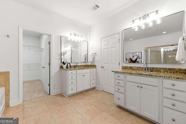 5534 Parkerton Ln, Sandy Springs, GA 30342 - full bath with a stall shower, two vanities, a garden tub, tile patterned flooring, and a spacious closet