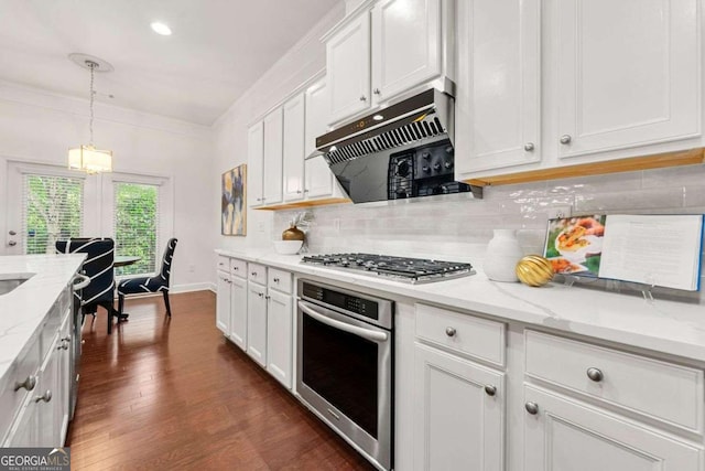 5534 Parkerton Ln, Sandy Springs, GA 30342 - kitchen featuring stainless steel appliances, exhaust hood, white cabinetry, decorative backsplash, and dark wood finished floors