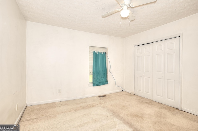 67 Cotton St, Commerce, GA 30529 - unfurnished bedroom featuring carpet, a textured ceiling, a closet, and a ceiling fan