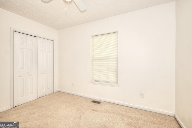 67 Cotton St, Commerce, GA 30529 - unfurnished bedroom with carpet floors, a closet, a textured ceiling, and a ceiling fan