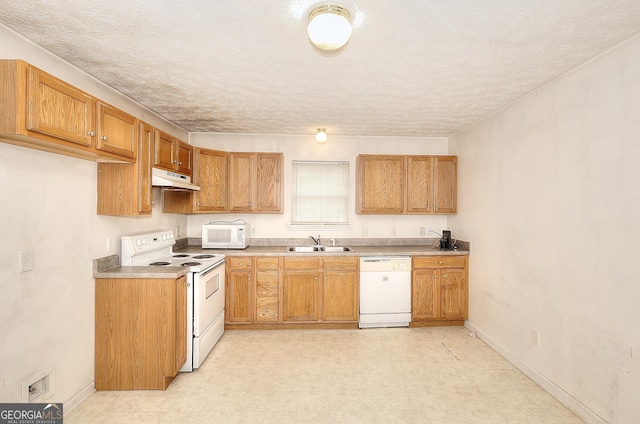 67 Cotton St, Commerce, GA 30529 - kitchen featuring white appliances, under cabinet range hood, brown cabinetry, light floors, and light countertops
