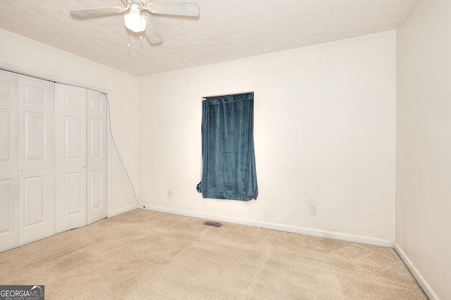 67 Cotton St, Commerce, GA 30529 - unfurnished bedroom with carpet flooring, a textured ceiling, a closet, and a ceiling fan