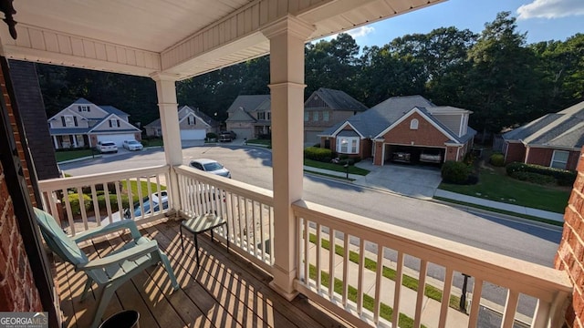 2435 Hickory Station Cir, Snellville, GA 30078 - wooden porch with a residential view, a garage, and driveway