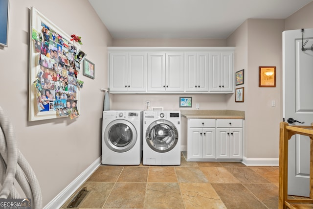 290 Vinson Rd, Tignall, GA 30668 - washroom with washing machine and clothes dryer, cabinet space, and light stone finish flooring
