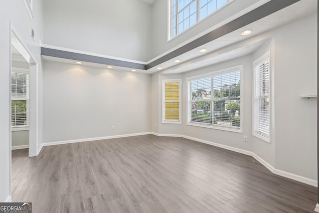 2379 Fallbrook Ct, Duluth, GA 30096 - unfurnished room with healthy amount of natural light, a high ceiling, wood finished floors, and recessed lighting