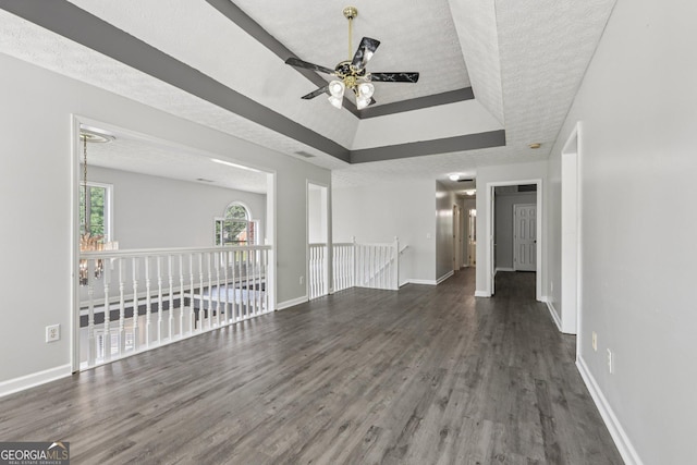 2379 Fallbrook Ct, Duluth, GA 30096 - unfurnished living room with a raised ceiling, wood finished floors, a ceiling fan, and a textured ceiling
