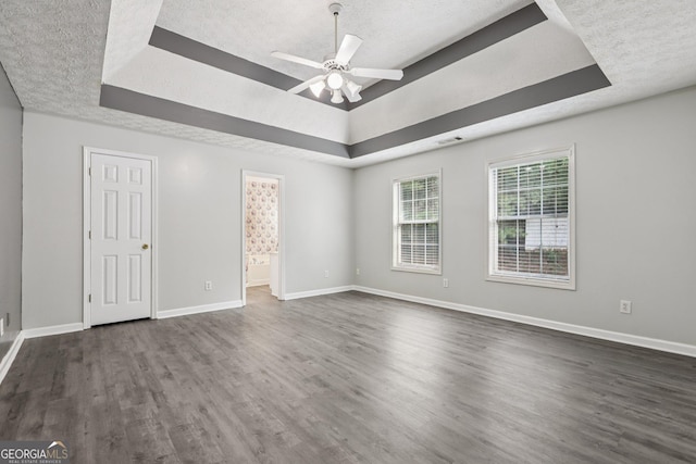 2379 Fallbrook Ct, Duluth, GA 30096 - spare room with a raised ceiling, dark wood-type flooring, ceiling fan, and a textured ceiling