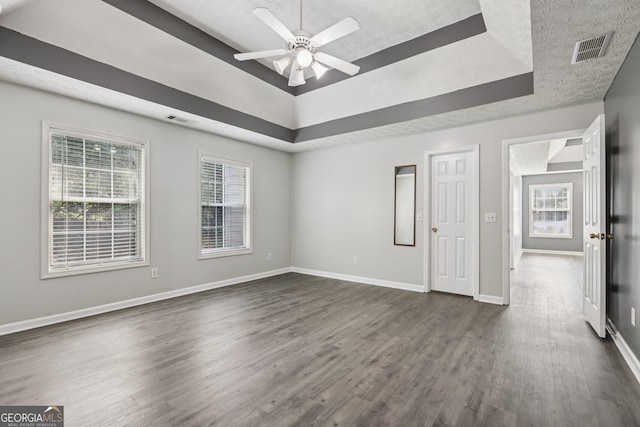 2379 Fallbrook Ct, Duluth, GA 30096 - unfurnished room featuring a tray ceiling, dark wood finished floors, a textured ceiling, and a ceiling fan