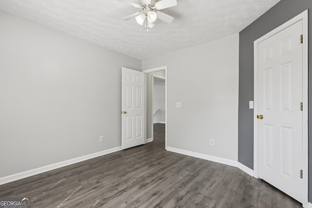 2379 Fallbrook Ct, Duluth, GA 30096 - unfurnished bedroom featuring a textured ceiling, dark wood finished floors, and ceiling fan