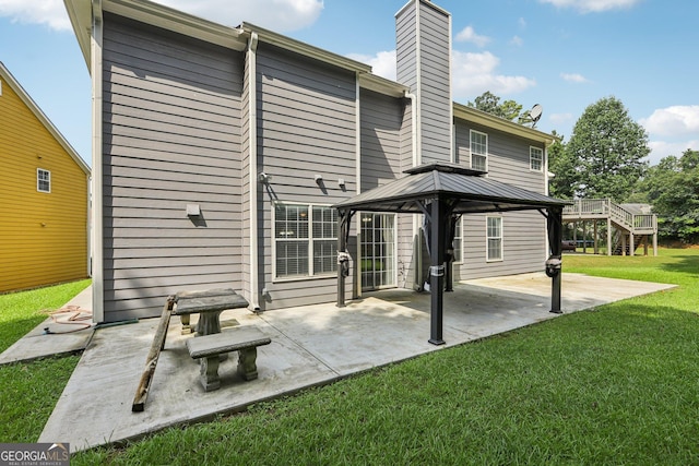 2379 Fallbrook Ct, Duluth, GA 30096 - back of property featuring a gazebo, a yard, a chimney, and a patio area