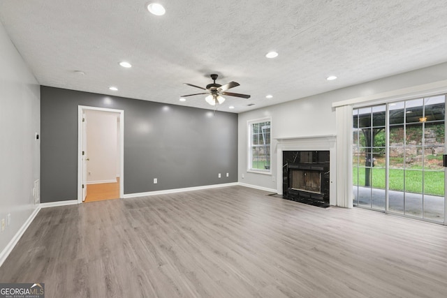 2379 Fallbrook Ct, Duluth, GA 30096 - unfurnished living room featuring a ceiling fan, recessed lighting, wood finished floors, healthy amount of natural light, and a textured ceiling