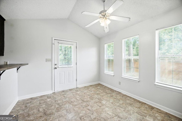 4801 Wilson Rd, Macon, GA 31206 - unfurnished dining area with a textured ceiling, a ceiling fan, vaulted ceiling, and tile patterned floors