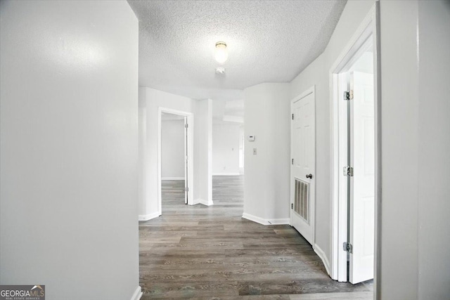 4801 Wilson Rd, Macon, GA 31206 - hall featuring wood finished floors and a textured ceiling