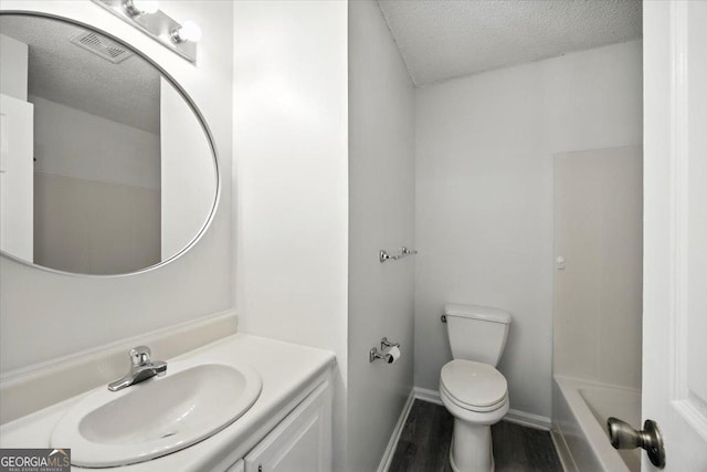 4801 Wilson Rd, Macon, GA 31206 - full bathroom featuring a textured ceiling, vanity, and wood finished floors