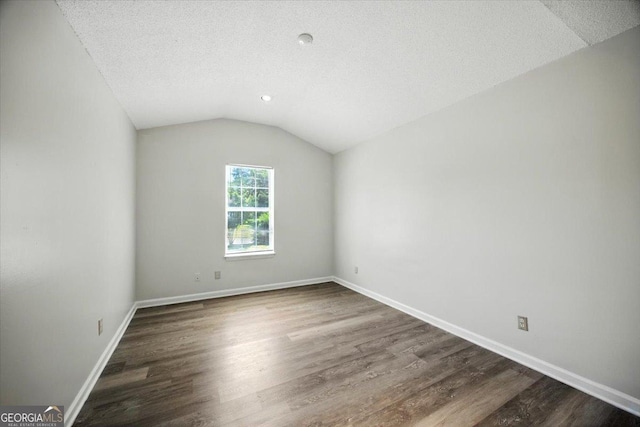 4801 Wilson Rd, Macon, GA 31206 - unfurnished room with dark wood-type flooring, vaulted ceiling, a textured ceiling, and recessed lighting