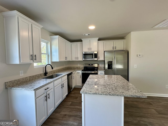 294 Stancil Dr, Toccoa, GA 30577 - kitchen with appliances with stainless steel finishes, a kitchen island, white cabinets, dark wood-style flooring, and recessed lighting