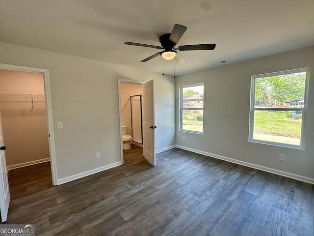 294 Stancil Dr, Toccoa, GA 30577 - unfurnished bedroom with a spacious closet, dark wood-style floors, ensuite bath, ceiling fan, and a closet