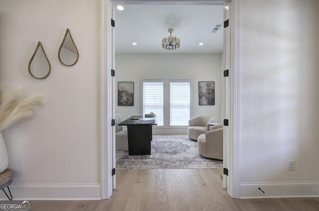 841 Keystone Dr, Woodstock, GA 30188 - hallway with wood finished floors, a chandelier, recessed lighting, and a desk