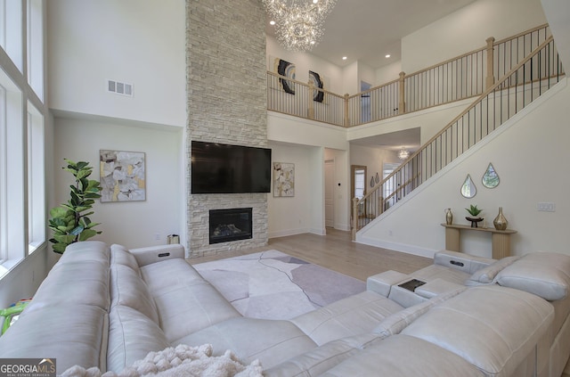841 Keystone Dr, Woodstock, GA 30188 - living area with a high ceiling, stairway, wood finished floors, a chandelier, and healthy amount of natural light