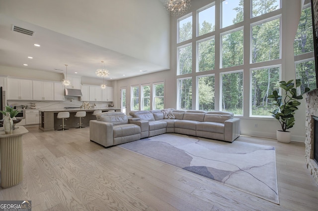 841 Keystone Dr, Woodstock, GA 30188 - living area featuring a chandelier, plenty of natural light, light wood finished floors, recessed lighting, and a high ceiling