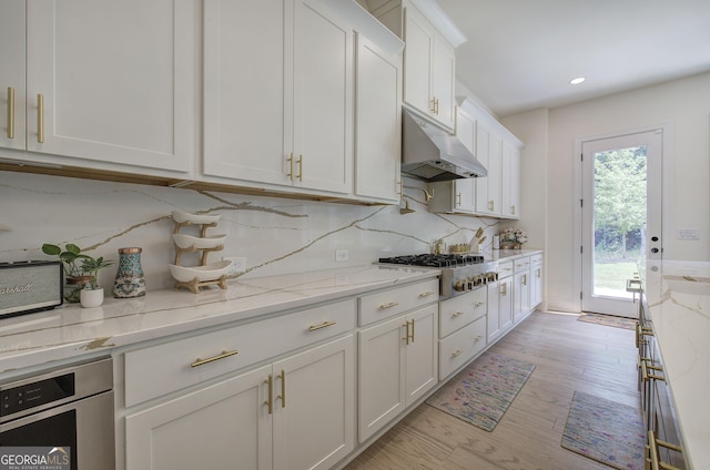 841 Keystone Dr, Woodstock, GA 30188 - kitchen featuring under cabinet range hood, appliances with stainless steel finishes, white cabinetry, backsplash, and recessed lighting