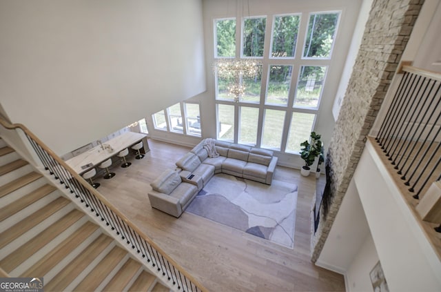 841 Keystone Dr, Woodstock, GA 30188 - living room featuring healthy amount of natural light, stairway, wood finished floors, and a chandelier
