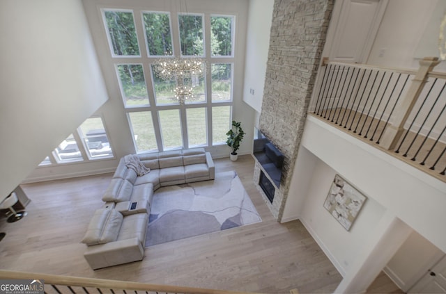 841 Keystone Dr, Woodstock, GA 30188 - living room featuring light wood finished floors, plenty of natural light, a chandelier, and a high ceiling