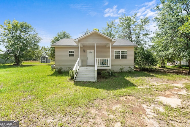 265 Hidden Hammock Dr, Vidalia, GA 30474 - rear view of house with a storage unit and a lawn