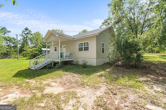 265 Hidden Hammock Dr, Vidalia, GA 30474 - view of front facade featuring covered porch and a front lawn