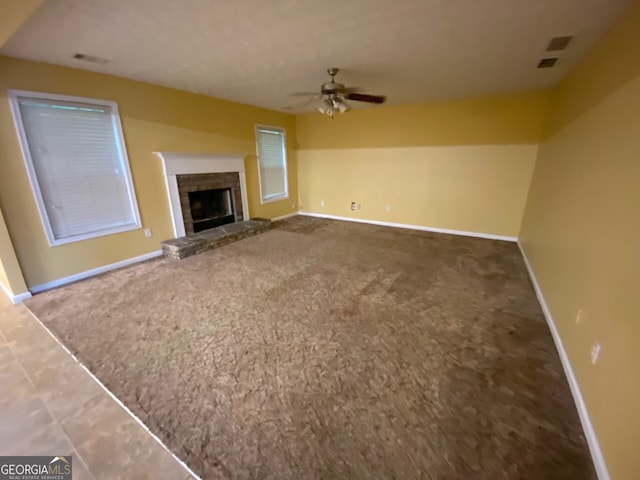 1472 Queenie Smith Rd NE, Conyers, GA 30012 - unfurnished living room featuring ceiling fan, carpet, and a fireplace with raised hearth