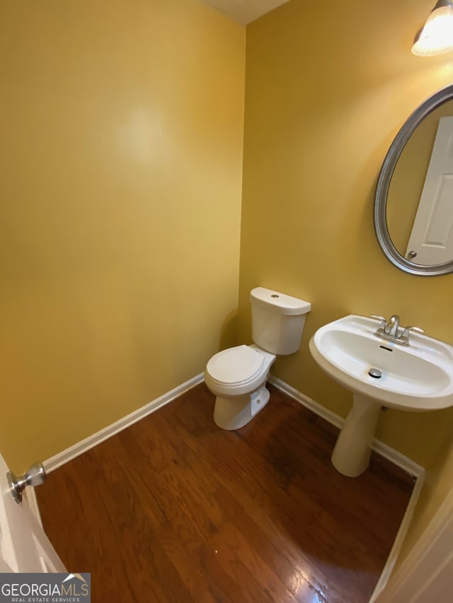 1472 Queenie Smith Rd NE, Conyers, GA 30012 - half bath featuring wood finished floors and toilet